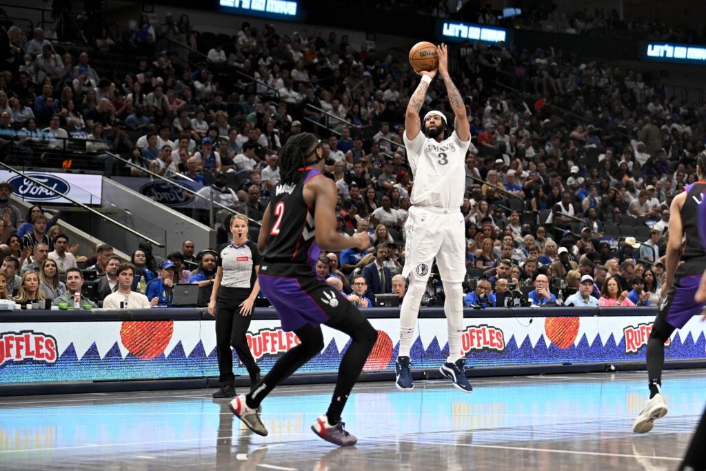 Apr 11, 2025; Dallas, Texas, USA; Dallas Mavericks forward Anthony Davis (3) makes a three point shot over Toronto Raptors forward Jonathan Mogbo (2) during the second half at the American Airlines Center. Mandatory Credit: Jerome Miron-Imagn Images