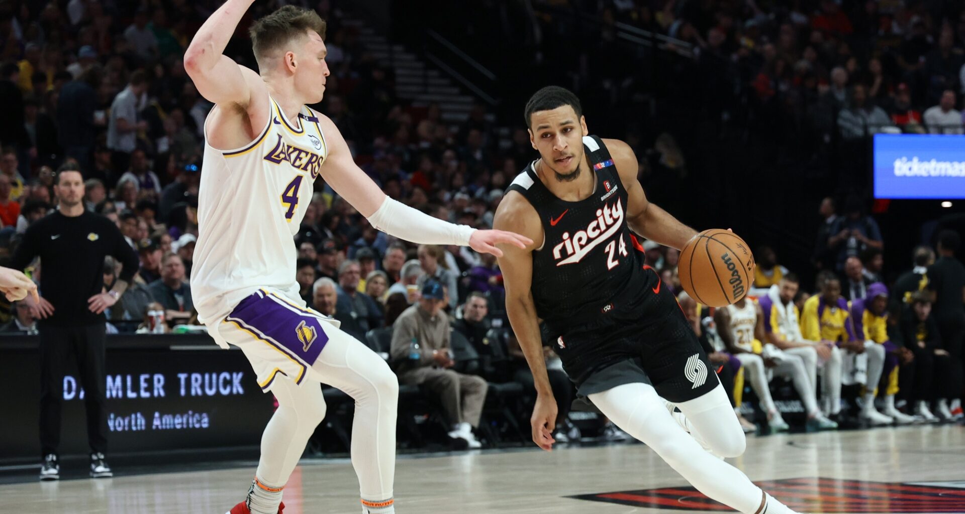 Apr 13, 2025; Portland, Oregon, USA; Portland Trail Blazers forward Kris Murray (24) dribbles the ball past Los Angeles Lakers guard Dalton Knecht (4) in the first half at Moda Center. Mandatory Credit: Jaime Valdez-Imagn Images