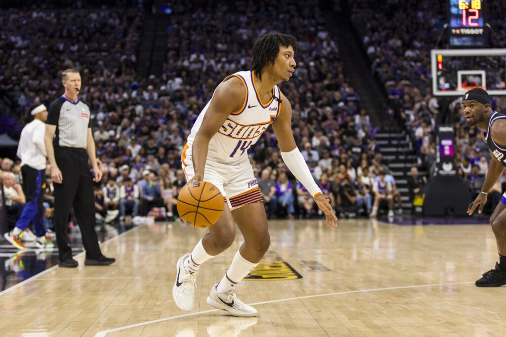 Apr 13, 2025; Sacramento, California, USA; Phoenix Suns guard TyTy Washington Jr. (14) dribbles against the Sacramento Kings during the fourth quarter at Golden 1 Center. Mandatory Credit: John Hefti-Imagn Images