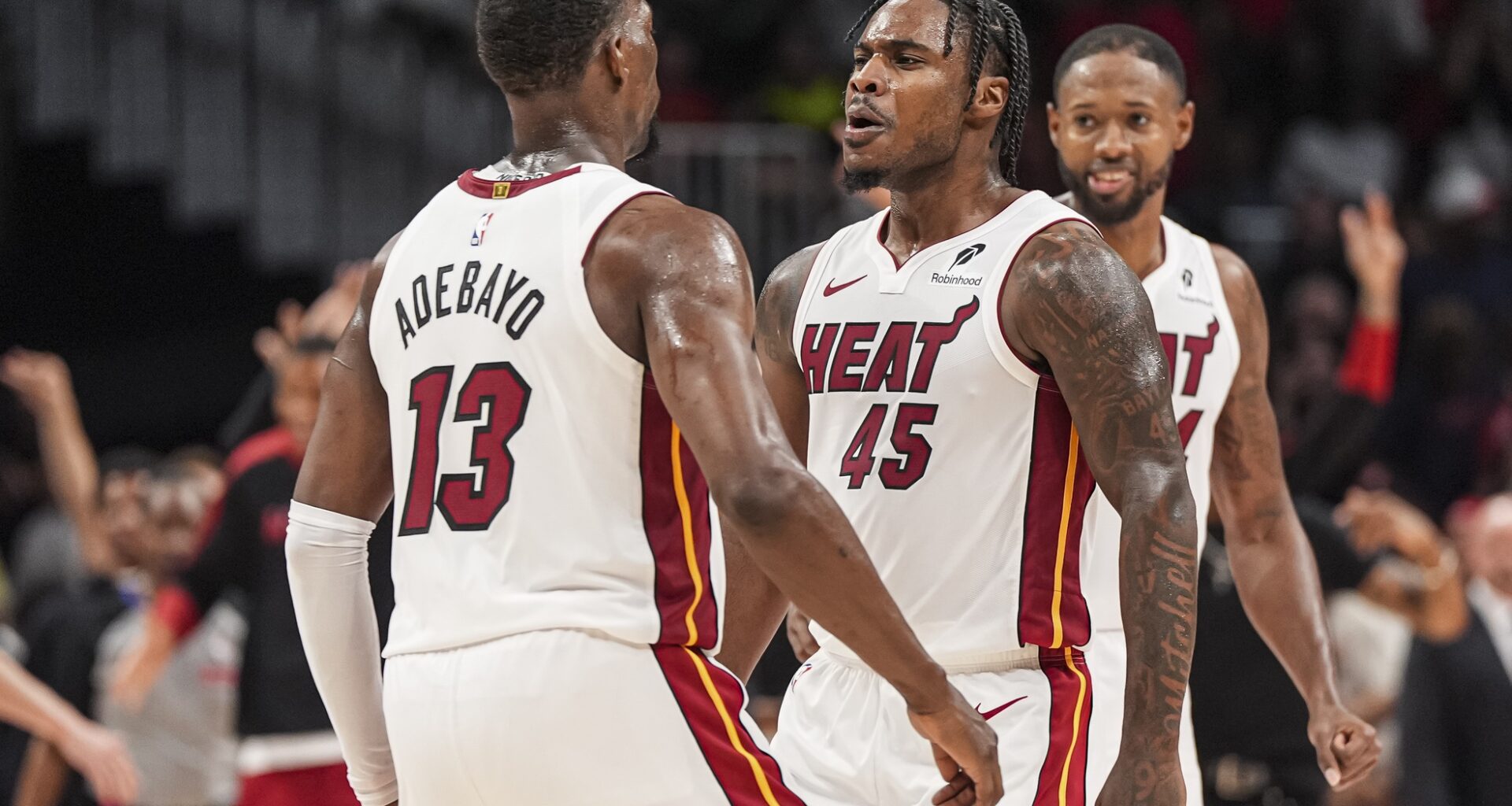 Miami Heat forward Bam Adebayo and guard Davion Mitchell chest bump