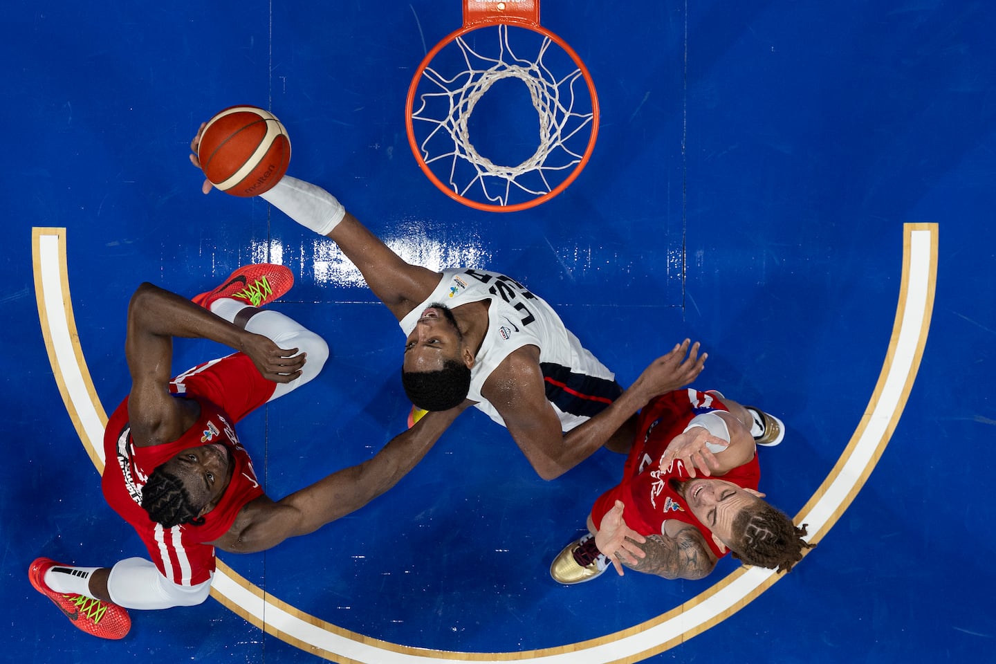 Baker (center) battles for a rebound against Puerto Rico during the FIBA AmeriCup Qualifiers.