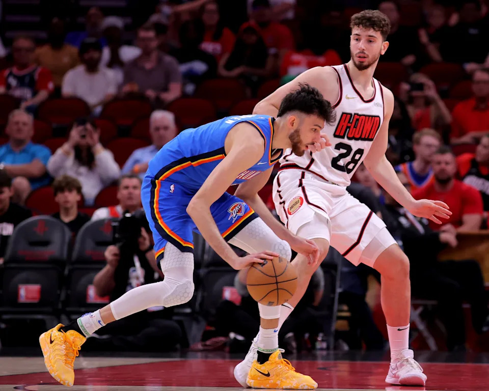 Apr 4, 2025; Houston, Texas, USA; Oklahoma City Thunder forward Chet Holmgren (7) handles the ball against Houston Rockets center Alperen Sengun (28) during the first quarter at Toyota Center. Mandatory Credit: Erik Williams-Imagn Images