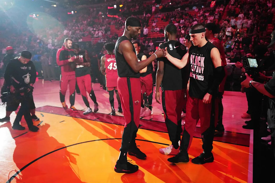 Feb 26, 2025; Miami, Florida, USA; Miami Heat center Bam Adebayo, left, and guard Tyler Herro (14) greet each other during team introductions before the game against the Atlanta Hawks at Kaseya Center. Mandatory Credit: Jim Rassol-Imagn Images