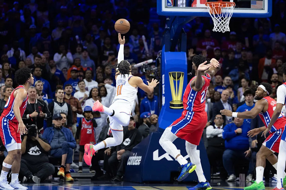 Nov 12, 2024; Philadelphia, Pennsylvania, USA; New York Knicks guard Jalen Brunson (11) drives for a shot against Philadelphia 76ers center Joel Embiid (21) during the third quarter at Wells Fargo Center. Mandatory Credit: Bill Streicher-Imagn Images