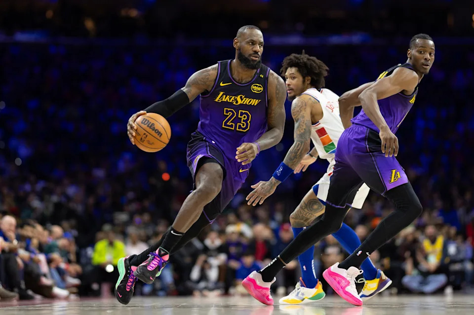 Jan 28, 2025; Philadelphia, Pennsylvania, USA; Los Angeles Lakers forward LeBron James (23) dribbles past Philadelphia 76ers guard Kelly Oubre Jr. (9) during the second quarter at Wells Fargo Center. Mandatory Credit: Bill Streicher-Imagn Images