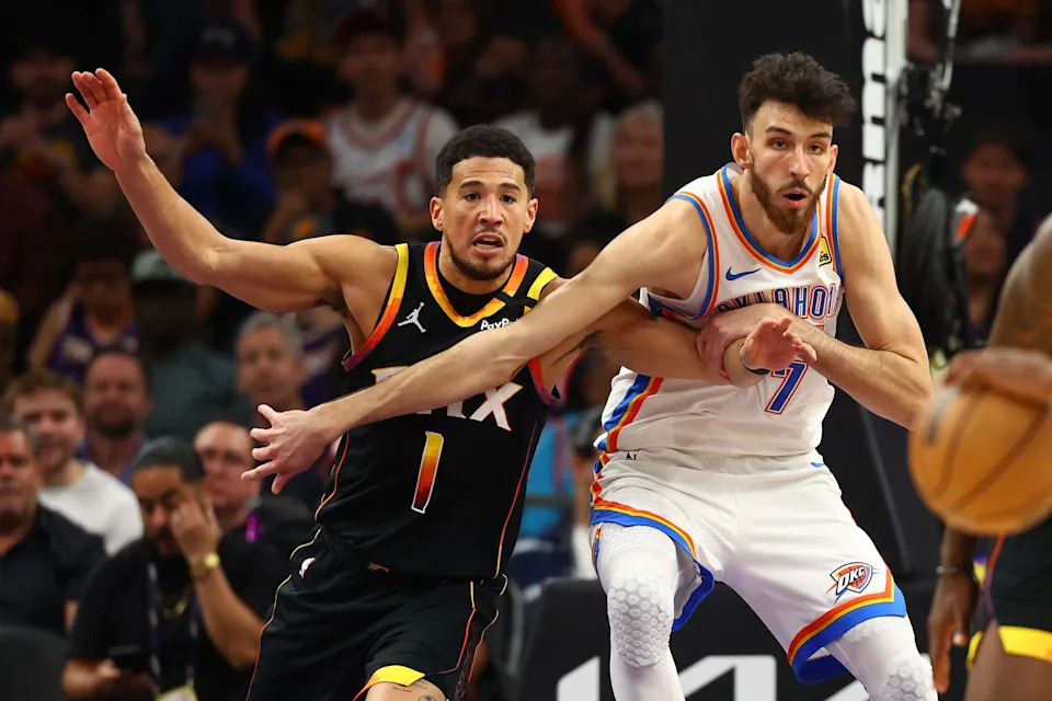 Apr 9, 2025; Phoenix, Arizona, USA; Phoenix Suns guard Devin Booker (1) and Oklahoma City Thunder forward Chet Holmgren (7) push for position during the first half at Footprint Center. Mandatory Credit: Mark J. Rebilas-Imagn Images