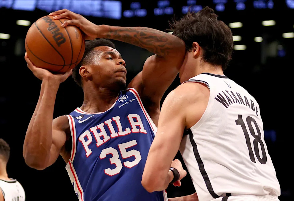 NEW YORK, NEW YORK - OCTOBER 03: Michael Foster Jr. #35 of the Philadelphia 76ers is called for an offensive foul on this play as he collides with Yuta Watanabe #18 of the Brooklyn Nets during a preseason game at Barclays Center on October 03, 2022 in the Brooklyn borough of New York City. The Philadelphia 76ers defeated the Brooklyn Nets 127-108. NOTE TO USER: User expressly acknowledges and agrees that, by downloading and or using this photograph, User is consenting to the terms and conditions of the Getty Images License Agreement. (Photo by Elsa/Getty Images)