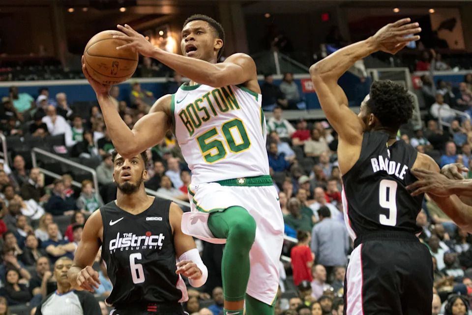 Apr 9, 2019; Washington, DC, USA; Boston Celtics guard PJ Dozier (50) shoots in between Washington Wizards guard Chasson Randle (9) and forward Troy Brown Jr. (6) during the second quarterat Capital One Arena. Mandatory Credit: Tommy Gilligan-USA TODAY Sports