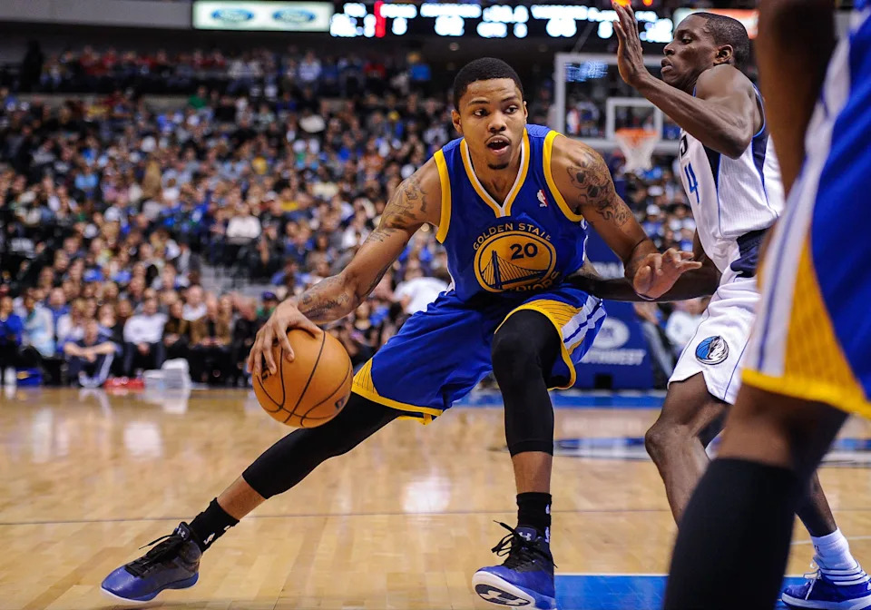 Feb 9, 2013; Dallas, TX, USA; Golden State Warriors shooting guard Kent Bazemore (20) drives to the basket past Dallas Mavericks point guard Darren Collison (4) during the game at the American Airlines Center. The Mavericks defeated the Warriors 116-91. Mandatory Credit: Jerome Miron-USA TODAY Sports