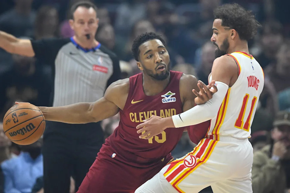 Atlanta Hawks guard Trae Young (11) defends Cleveland Cavaliers guard Donovan Mitchell (45) on Jan. 30, 2025, in Cleveland, Ohio.
