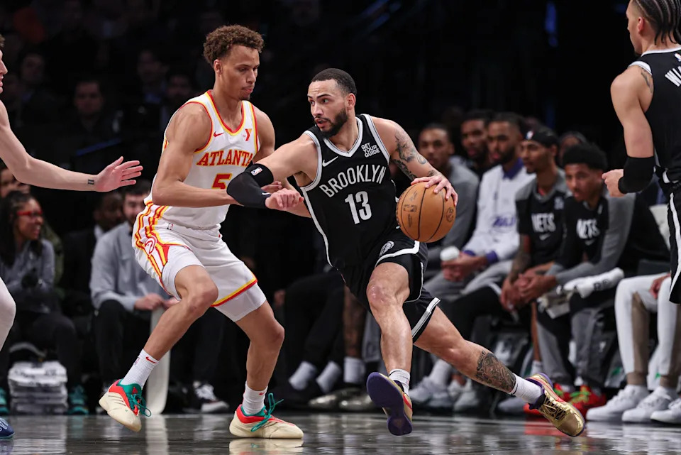 Mar 16, 2025; Brooklyn, New York, USA; Brooklyn Nets guard Tyrese Martin (13) dribbles against Atlanta Hawks guard Dyson Daniels (5) during the first quarter at Barclays Center. Mandatory Credit: Vincent Carchietta-Imagn Images