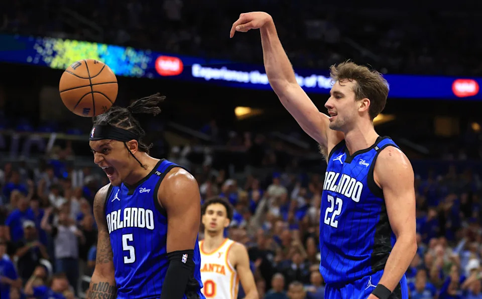 ORLANDO, FLORIDA - APRIL 15: Franz Wagner #22 and Paolo Banchero #5 of the Orlando Magic react to a play during the second half of an NBA play-in tournament game against the Atlanta Hawks at Kia Center on April 15, 2025 in Orlando, Florida. NOTE TO USER: User expressly acknowledges and agrees that, by downloading and or using this photograph, User is consenting to the terms and conditions of the Getty Images License Agreement. (Photo by Mike Ehrmann/Getty Images)