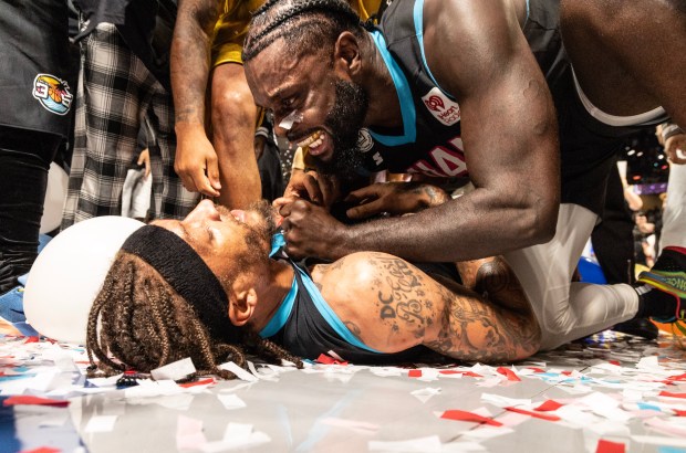 Miami 305's Michael Beasley (11) lies one the floor and celebrates with Lance Stephenson (1) after winning the championship game of the Big3 basketball game in Orlando, Fla., Sunday, Aug. 24, 2025. (Willie J. Allen Jr./Orlando Sentinel)
