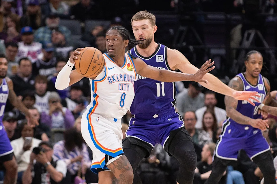 Nov 25, 2024; Sacramento, California, USA; Sacramento Kings forward Domantas Sabonis (11) defends against Oklahoma City Thunder forward Jalen Williams (8) during the second quarter at Golden 1 Center. Mandatory Credit: Ed Szczepanski-Imagn Images