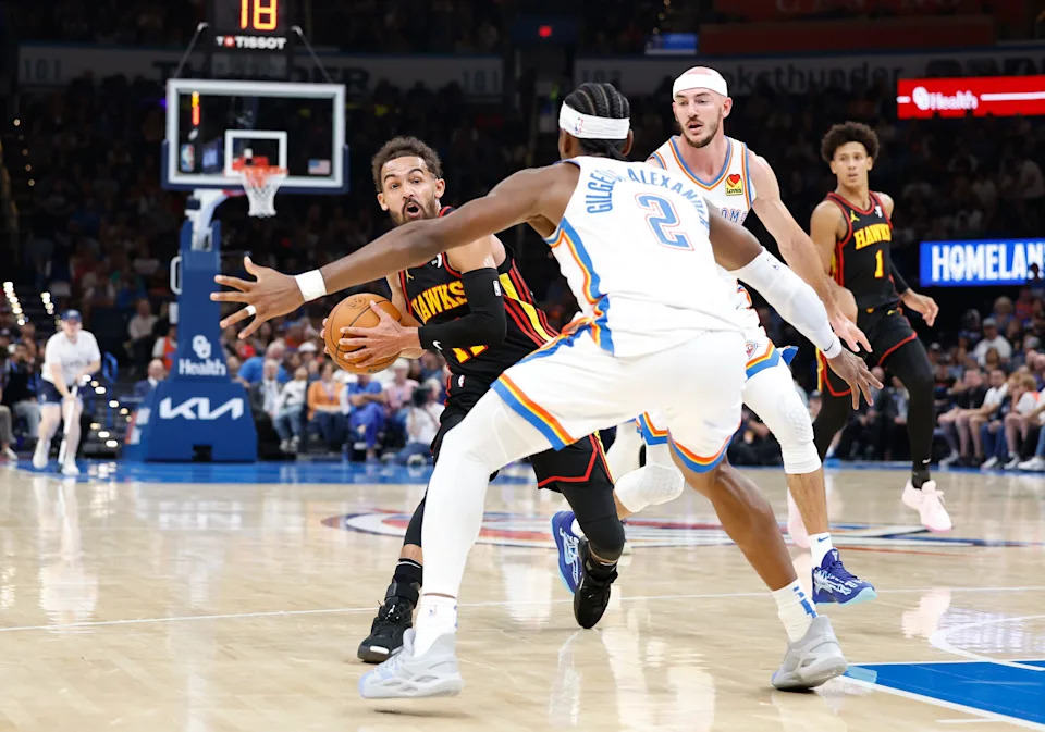 Oct 27, 2024; Oklahoma City, Oklahoma, USA; Atlanta Hawks guard Trae Young (11) is stopped by Oklahoma City Thunder guard Shai Gilgeous-Alexander (2) on a drive during the second quarter at Paycom Center. Mandatory Credit: Alonzo Adams-Imagn Images