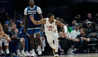 Cleveland Cavaliers guard Donovan Mitchell (45) gestures in front of Minnesota Timberwolves center Naz Reid (11) after hitting a 3-point basket in the first half of an NBA basketball game Monday, Feb. 10, 2025, in Cleveland. (AP Photo/Sue Ogrocki)