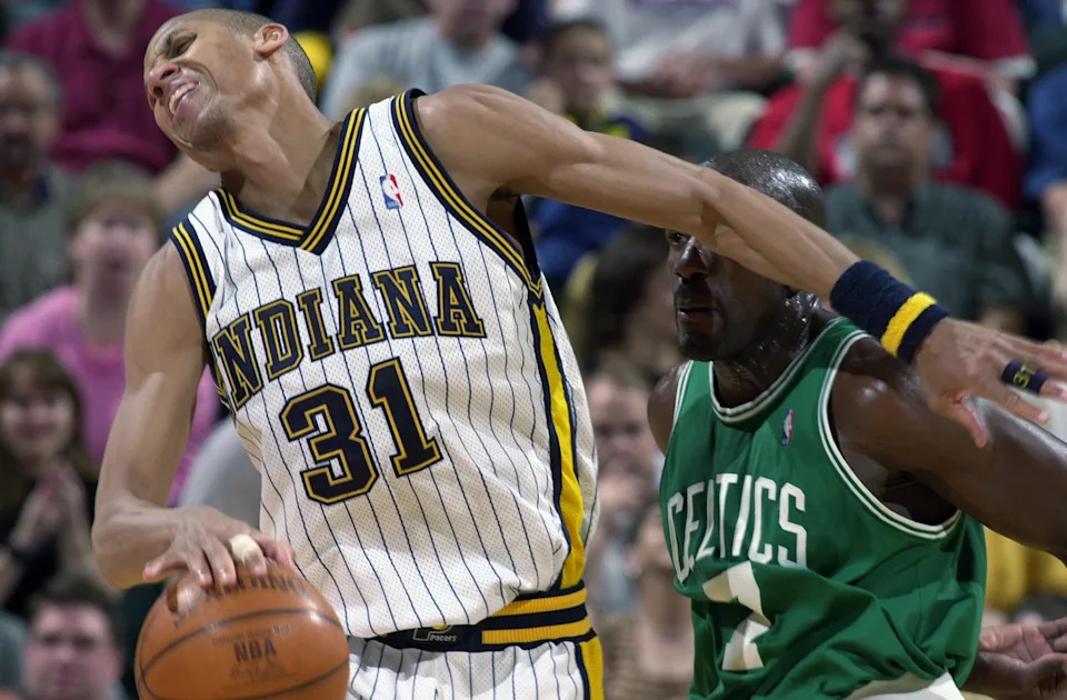 INDIANAPOLIS - APRIL 29: Reggie Miller #31 of the Indiana Pacers writhes in agony near Tony Delk #7 of the Boston Celtics in Game five of the Eastern Conference Quarterfinals during the 2003 NBA Playoffs at Conseco Fieldhouse on April 29, 2003 in Indianapolis, Indiana. The Pacers defeated the Celtics 93-88 in overtime. NOTE TO USER: User expressly acknowledges and agrees that, by downloading and/or using this Photograph, User is consenting to the terms and conditions of the Getty Images License Agreement. (Photo by Jonathan Daniel/Getty Images)