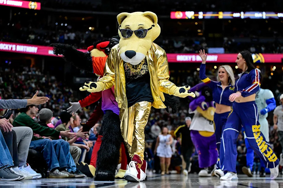 DENVER, COLORADO - MARCH 28: Denver Nuggets mascot Rocky is joined by other mascots including Colorado Rockies mascot Dinger in recognition of his birthday in a game between the Denver Nuggets and the Utah Jazz at Ball Arena on March 28, 2025 in Denver, Colorado. NOTE TO USER: User expressly acknowledges and agrees that, by downloading and or using this photograph, User is consenting to the terms and conditions of the Getty Images License Agreement. (Photo by Dustin Bradford/Getty Images)