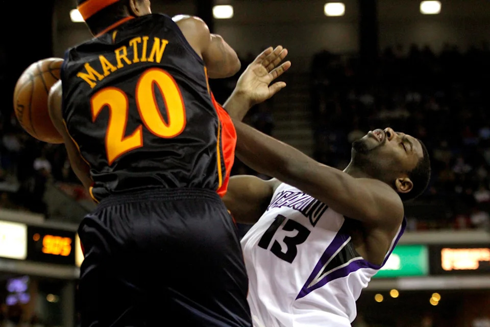 January 26, 2010; Sacramento, CA, USA; Sacramento Kings guard Tyreke Evans (13) runs into Golden State Warriors guard Cartier Martin (20) after being fouled in the second half at Arco Arena. The Kings defeated the Warriors 99-96. Mandatory Credit: Cary Edmondson-USA TODAY Sports