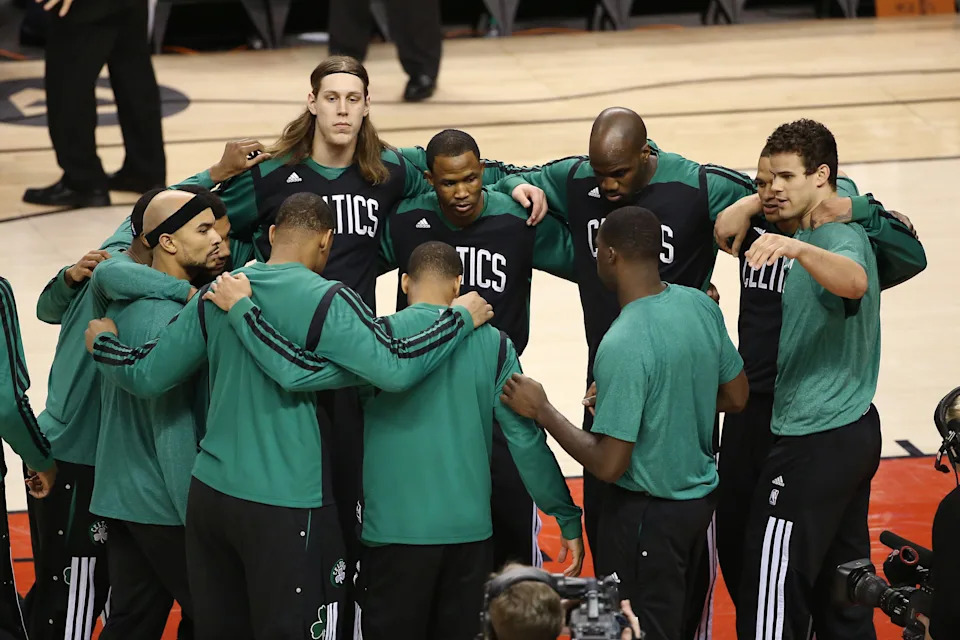Mar 28, 2014; Toronto, Ontario, CAN; Boston Celtics guard Jerryd Bayless (11) and forward Kelly Olynyk (41) and teammates huddle before the start of their game against the Toronto Raptors at Air Canada Centre. The Raptors beat the Celtics 105-103. Mandatory Credit: Tom Szczerbowski-USA TODAY Sports