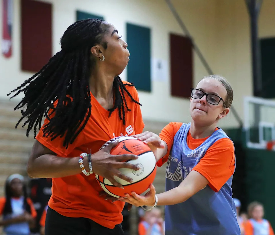 Sophia Losky of Aurora, right, tries to steal the ball away from coach Sunni Smith during a tournament round at Aurora High School on July 31.