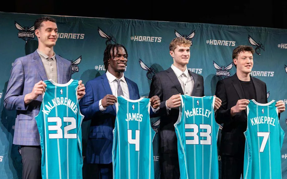 Hornet’s new players hold up jerseys during a press conference introducing them in Charlotte, N.C., on Friday, June 27, 2025.