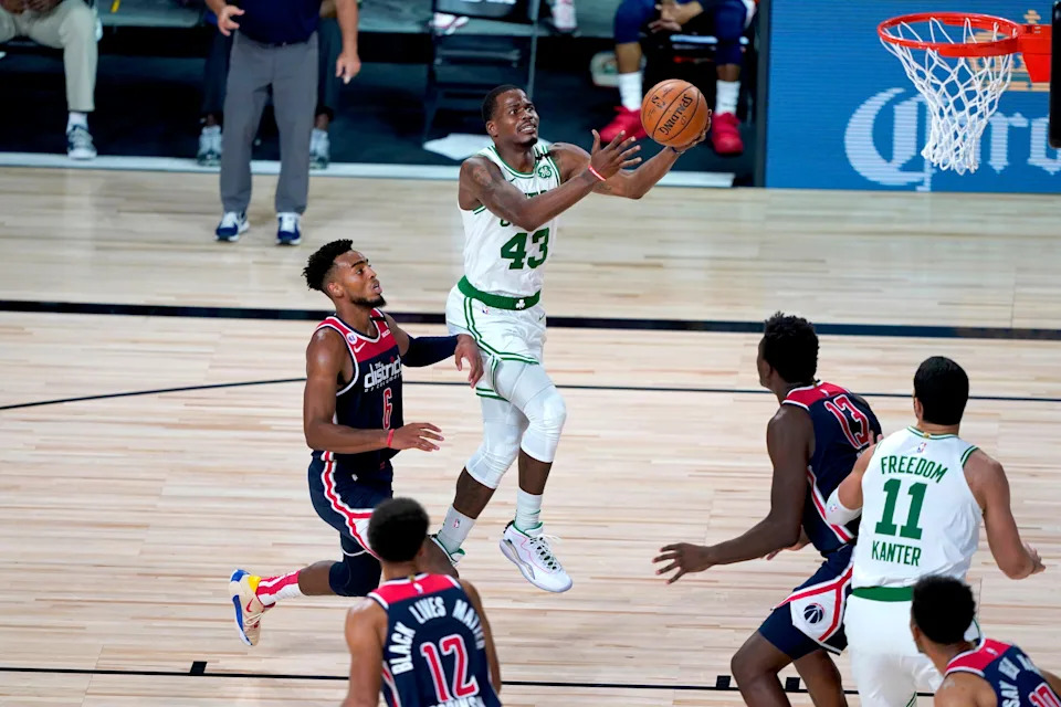 Aug 13, 2020; Lake Buena Vista, Florida, USA; Boston Celtics' Javonte Green (43) heads to the basket past Washington Wizards' Troy Brown Jr. (6) during the second half of an NBA basketball game Thursday, Aug. 13, 2020 in Lake Buena Vista, Fl. at ESPN Wide World of Sports Complex. Mandatory Credit: Ashley Landis/Pool Photo-USA TODAY Sports