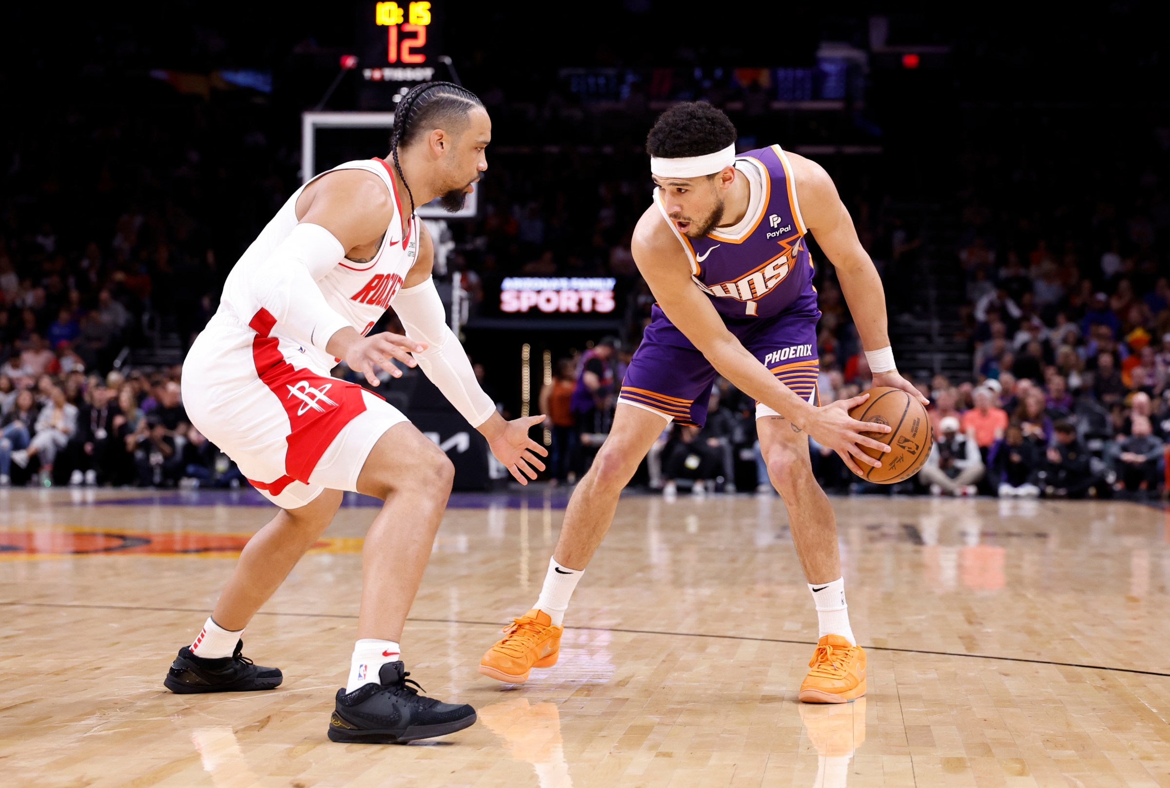 PHOENIX, ARIZONA - MARCH 02: Devin Booker #1 of the Phoenix Suns posts up on Dillon Brooks #9 of the Houston Rockets during the game at Footprint Center on March 02, 2024 in Phoenix, Arizona. The Rockets defeated the Suns 118-109. NOTE TO USER: User expressly acknowledges and agrees that, by downloading and or using this photograph, User is consenting to the terms and conditions of the Getty Images License Agreement. (Photo by Chris Coduto/Getty Images)