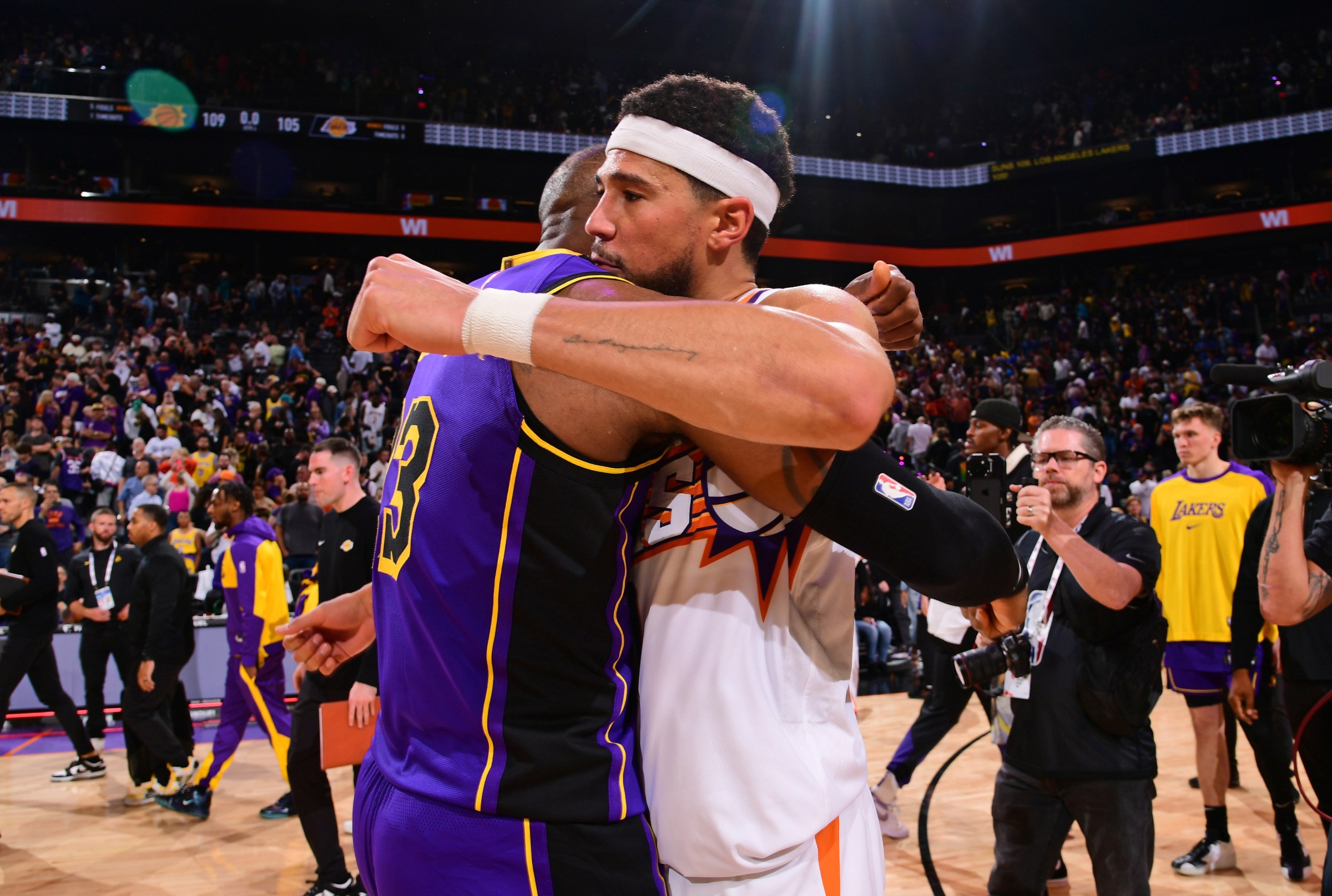PHOENIX, AZ - OCTOBER 28: LeBron James #23 of the Los Angeles Lakers greets Devin Booker #1 of the Phoenix Suns after the game on October 28, 2024 at Footprint Center in Phoenix, Arizona. NOTE TO USER: User expressly acknowledges and agrees that, by downloading and or using this photograph, user is consenting to the terms and conditions of the Getty Images License Agreement. Mandatory Copyright Notice: Copyright 2024 NBAE (Photo by Kate Frese/NBAE via Getty Images)