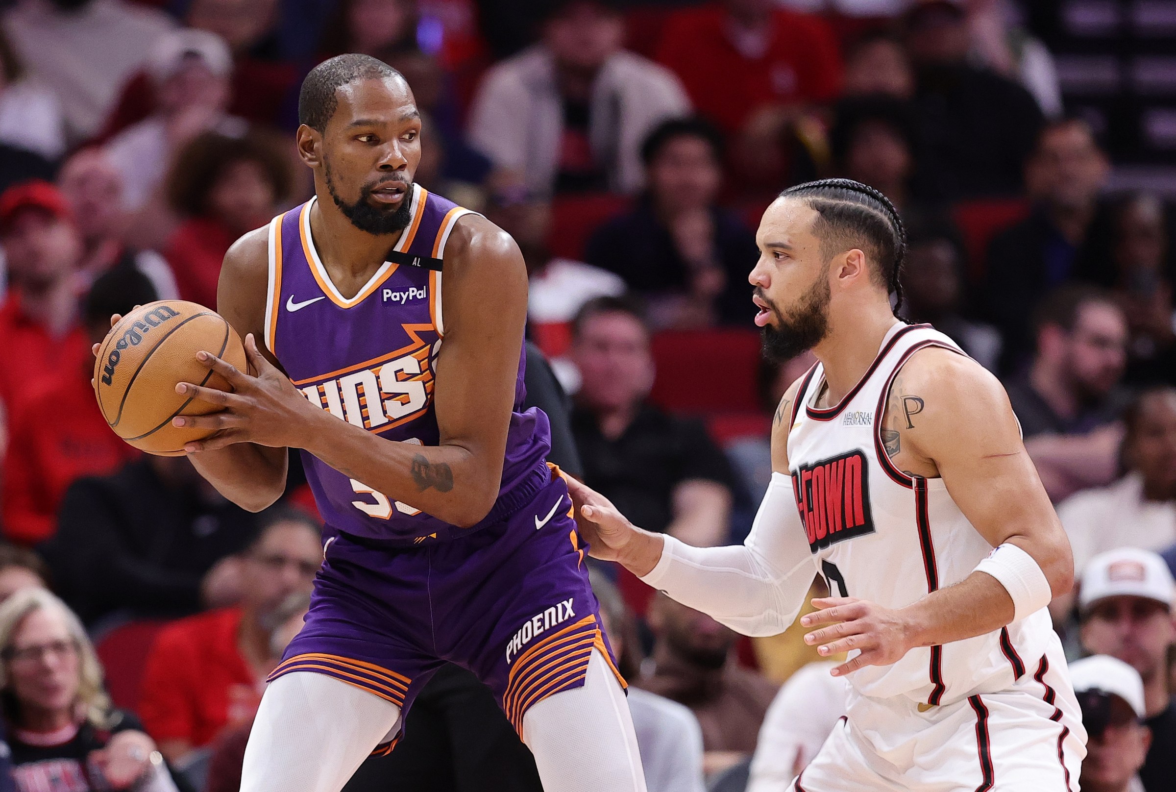 HOUSTON, TEXAS - FEBRUARY 12: Kevin Durant #35 of the Phoenix Suns works against Dillon Brooks #9 of the Houston Rockets during the first half at Toyota Center on February 12, 2025 in Houston, Texas. NOTE TO USER: User expressly acknowledges and agrees that, by downloading and or using this photograph, User is consenting to the terms and conditions of the Getty Images License Agreement. (Photo by Alex Slitz/Getty Images)