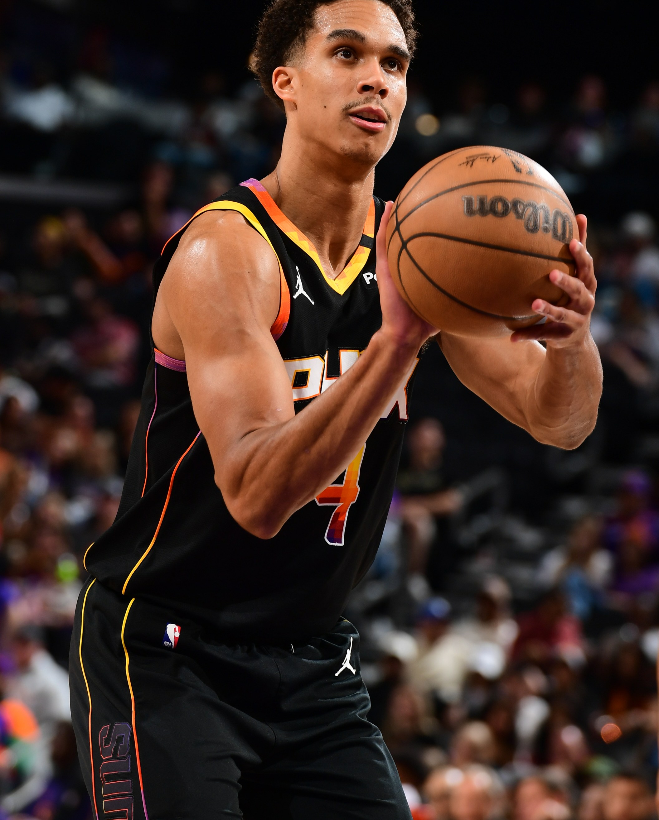 PHOENIX, AZ - APRIL 9: Oso Ighodaro #4 of the Phoenix Suns shoots a free throw during the game against the Oklahoma City Thunder on April 9, 2025 at PHX Arena in Phoenix, Arizona. NOTE TO USER: User expressly acknowledges and agrees that, by downloading and or using this photograph, user is consenting to the terms and conditions of the Getty Images License Agreement. Mandatory Copyright Notice: Copyright 2025 NBAE (Photo by Kate Frese/NBAE via Getty Images)