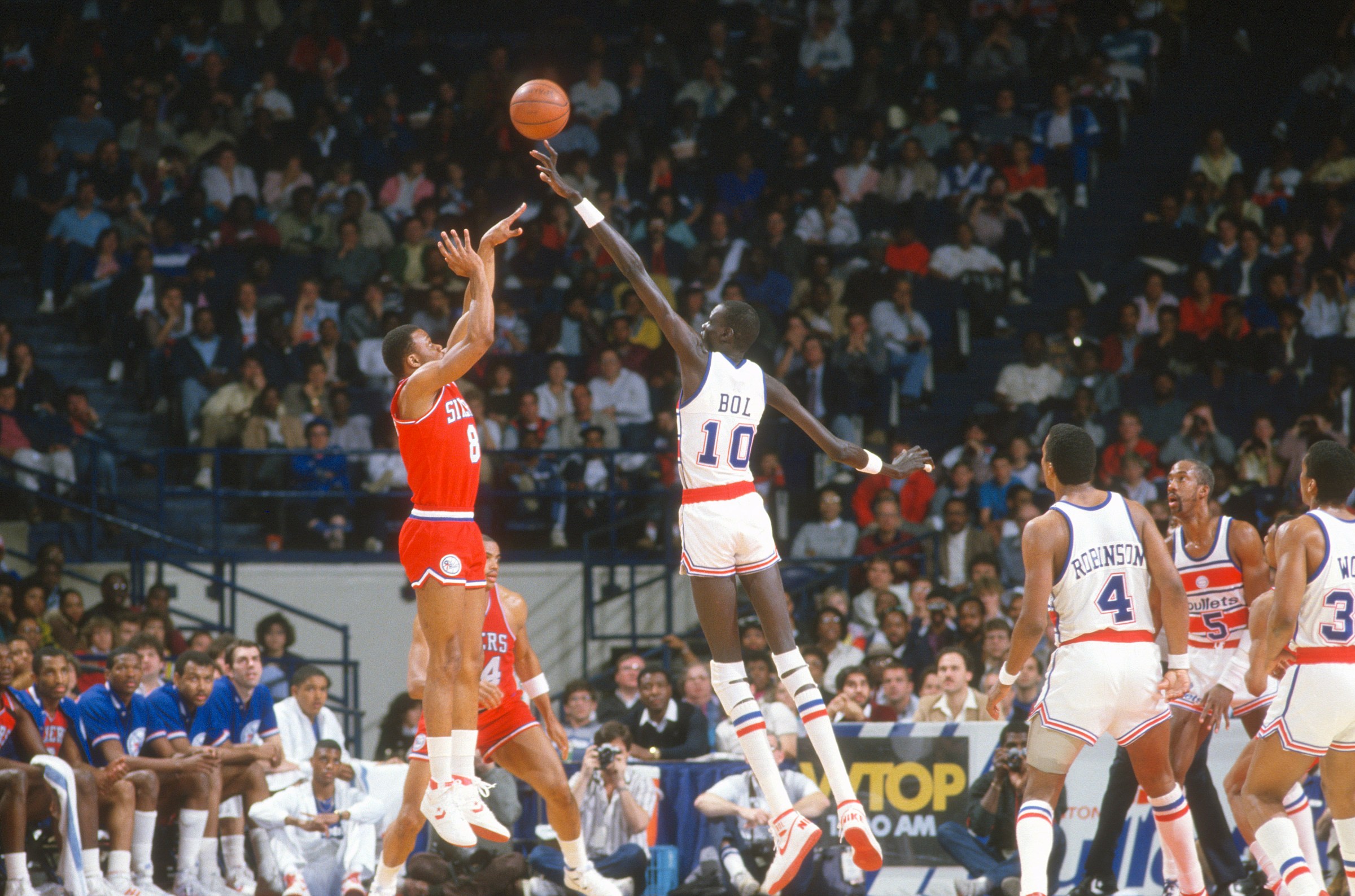 Manute Bol doing what he did…blocking a shot.