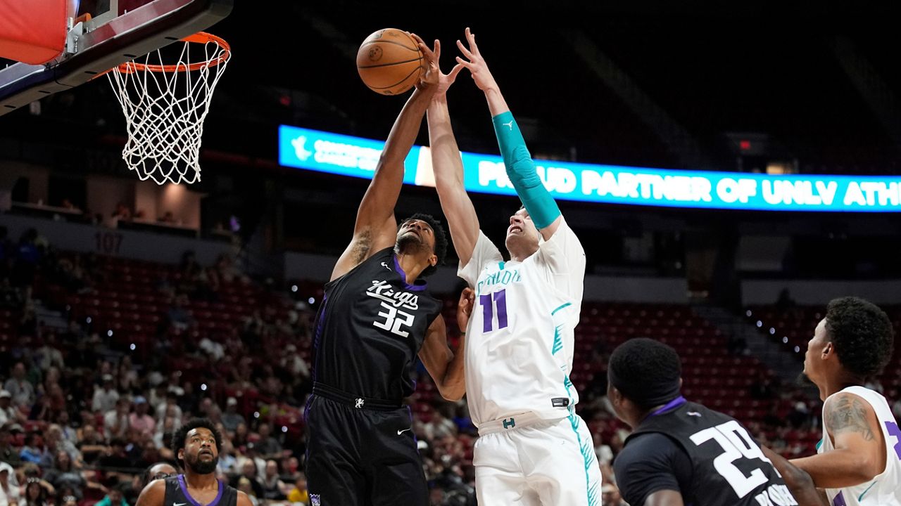 Sacramento Kings' Dylan Cardwell, left, and Charlotte Hornets' Ryan Kalkbrenner battle for a rebound during an NBA Summer League championship basketball game Sunday, July 20, 2025, in Las Vegas. (AP Photo/John Locher)