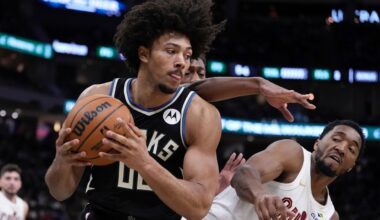 Milwaukee Bucks' Jericho Sims grabs a rebound in front of Cleveland Cavaliers' Donovan Mitchell during the first half of an NBA basketball game Sunday, Mar. 9, 2025, in Milwaukee.