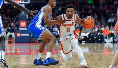 jj starling, in white syracuse basketball uniform, drives against duke's caleb foster