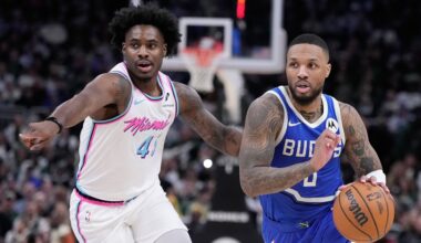 Milwaukee Bucks' Damian Lillard drives past Miami Heat's Davion Mitchell during the second half of an NBA basketball game Sunday, Feb. 23, 2025, in Milwaukee.