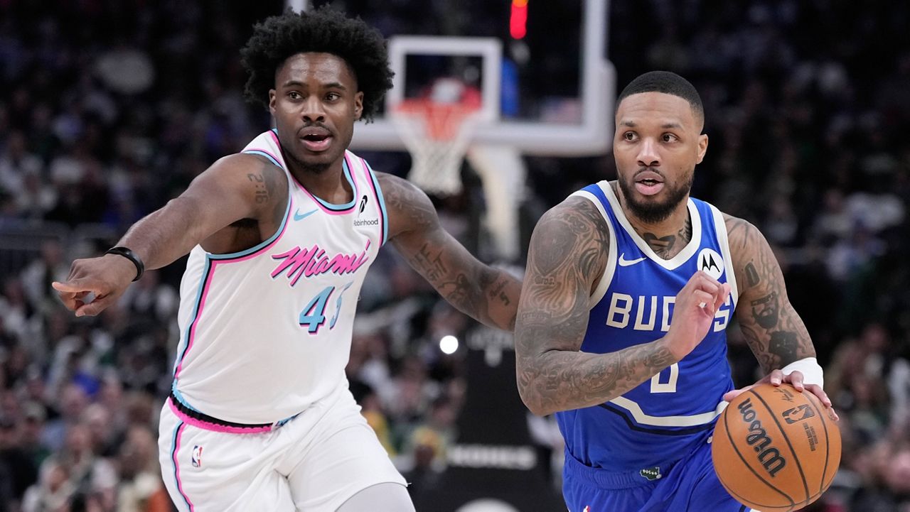 Milwaukee Bucks' Damian Lillard drives past Miami Heat's Davion Mitchell during the second half of an NBA basketball game Sunday, Feb. 23, 2025, in Milwaukee.