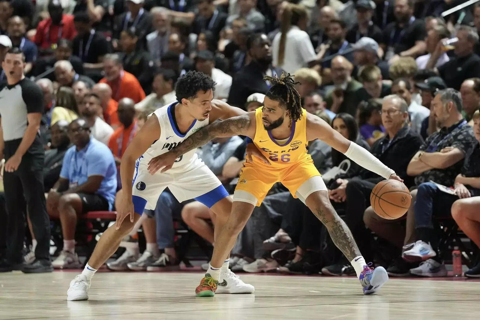 Los Angeles Lakers guard RJ Davis (26) dribbles against Dallas Mavericks guard Ryan Nembhard (9) in the first quarter of their game at Thomas & Mack Center (Image via Candice Ward-Imagn Images) Los Angeles Lakers guard RJ Davis (26) dribbles against Dallas Mavericks guard Ryan Nembhard (9) in the first quarter of their game at Thomas & Mack Center