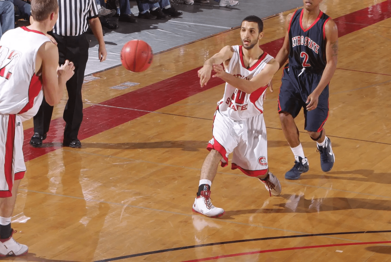 Mahmoud Abdelfattah in white SCSU jersey passing ball