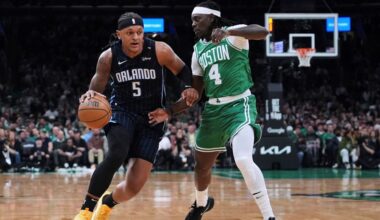 Orlando Magic forward Paolo Banchero (5) drives to the basket against Boston Celtics guard Jrue Holiday (4) during the first half in game 2 of a first-round NBA playoff basketball series, Wednesday, April 23, 2025, in Boston. (AP Photo/Charles Krupa)