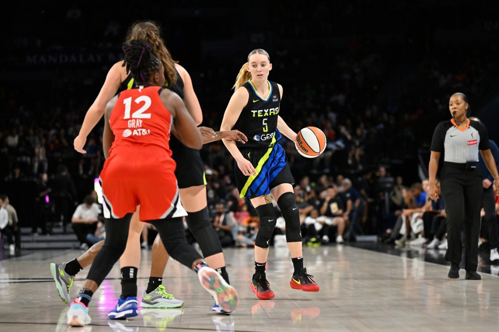 Paige Bueckers #5 of the Dallas Wings dribbling the ball during a game.