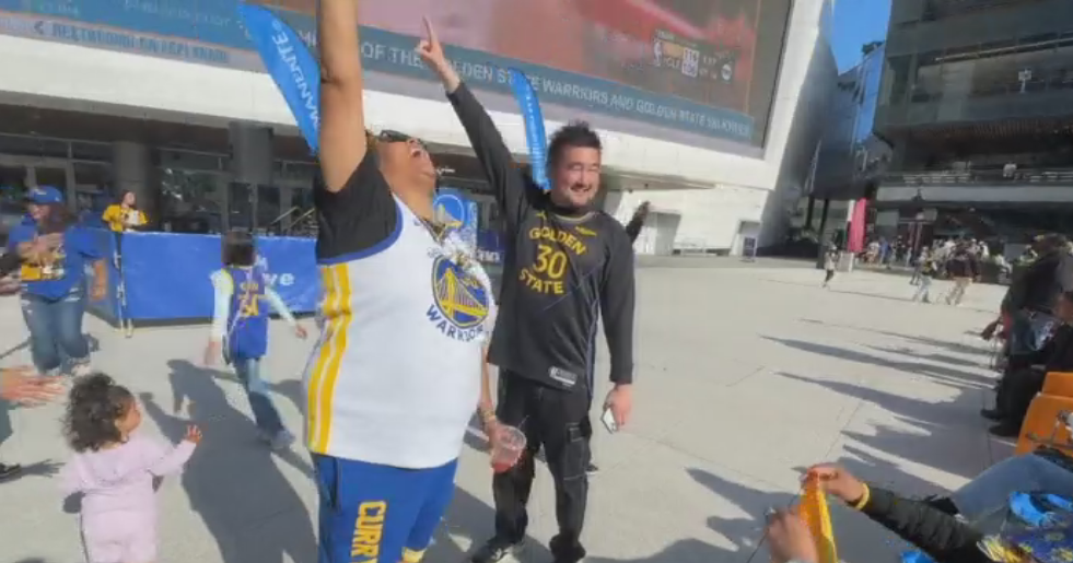 Warriors fans celebrate the team's win against the Rockets