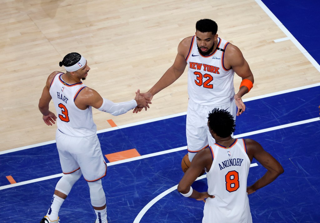Josh Hart #3 high-fives Karl-Anthony Towns #32 during a basketball game.