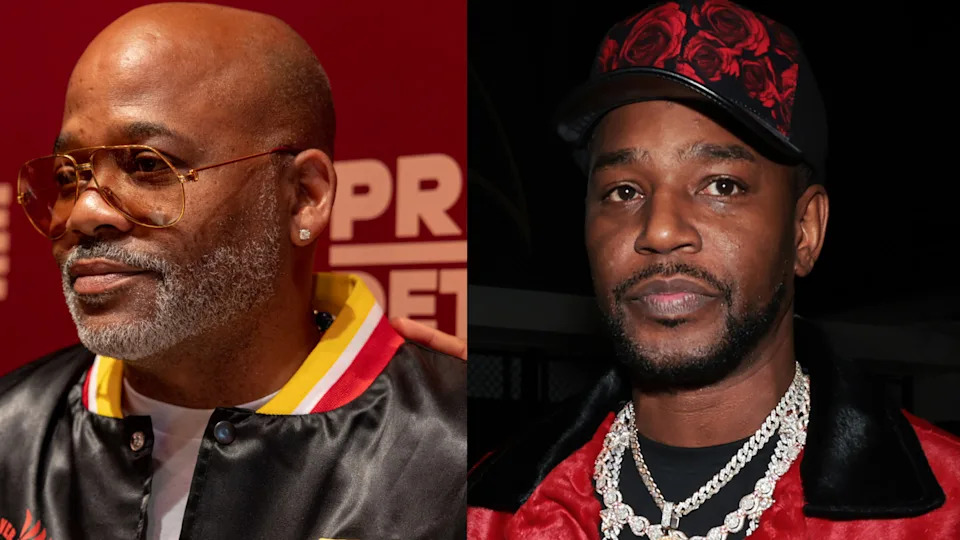 Damon Dash and Cam'ron, both wearing stylish outfits, pose for photos at an event.
