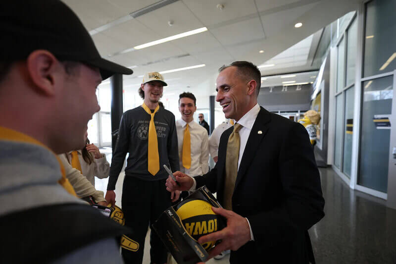 Iowa basketball coach Ben McCollum greets fans.
