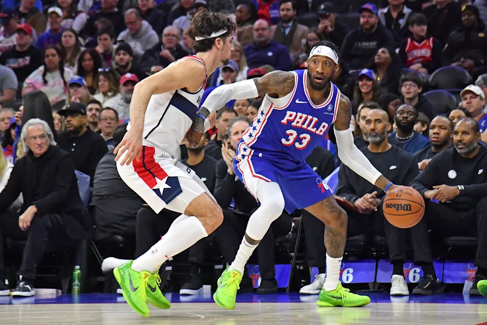 Dec 11, 2023; Philadelphia, Pennsylvania, USA; Philadelphia 76ers forward Robert Covington (33) is defended by Washington Wizards forward Deni Avdija (8) during the second quarter at Wells Fargo Center. Mandatory Credit: Eric Hartline-USA TODAY Sports