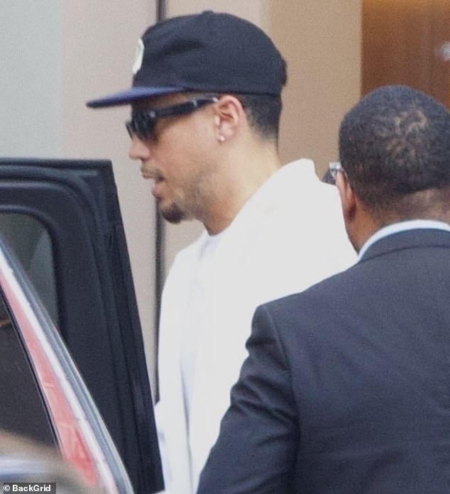 The basketball star wore an all-white outfit topped with a black hat and matching sunglasses