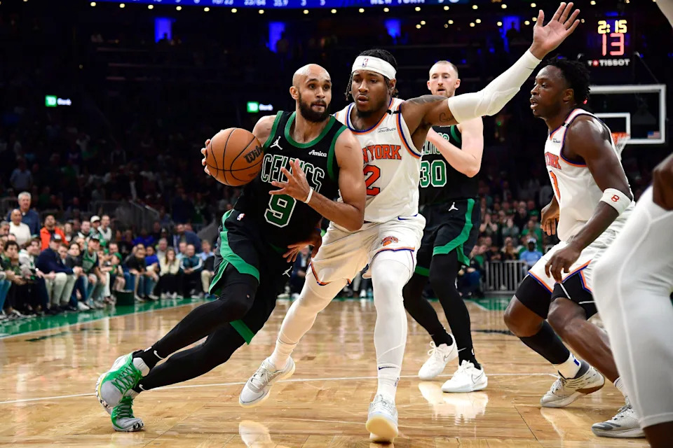 May 14, 2025; Boston, Massachusetts, USA; Boston Celtics guard Derrick White (9) controls the ball while New York Knicks guard Miles McBride (2) defends in the second half during game five of the second round for the 2025 NBA Playoffs at TD Garden. Mandatory Credit: Bob DeChiara-Imagn Images