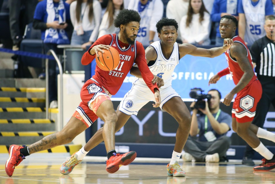Fresno State Bulldogs basketball player Mykell Robinson driving to the basket.