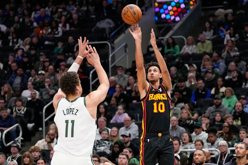 Mar 30, 2025; Milwaukee, Wisconsin, USA; Atlanta Hawks forward Zaccharie Risacher (10) shoots over Milwaukee Bucks center Brook Lopez (11) during the fourth quarter at Fiserv Forum. Mandatory Credit: Jeff Hanisch-Imagn Images